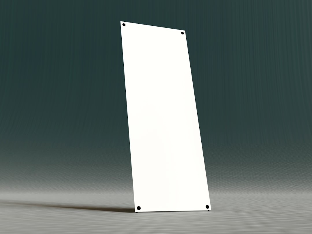 Blank 3D Vertical Banner Mockup A high-quality 3D render of a blank vertical display banner stand (often called an X-Banner or Roll-Up Banner). Ideal for graphic designers and marketers needing to present corporate branding, event advertising, or product promotion designs in a realistic setting.