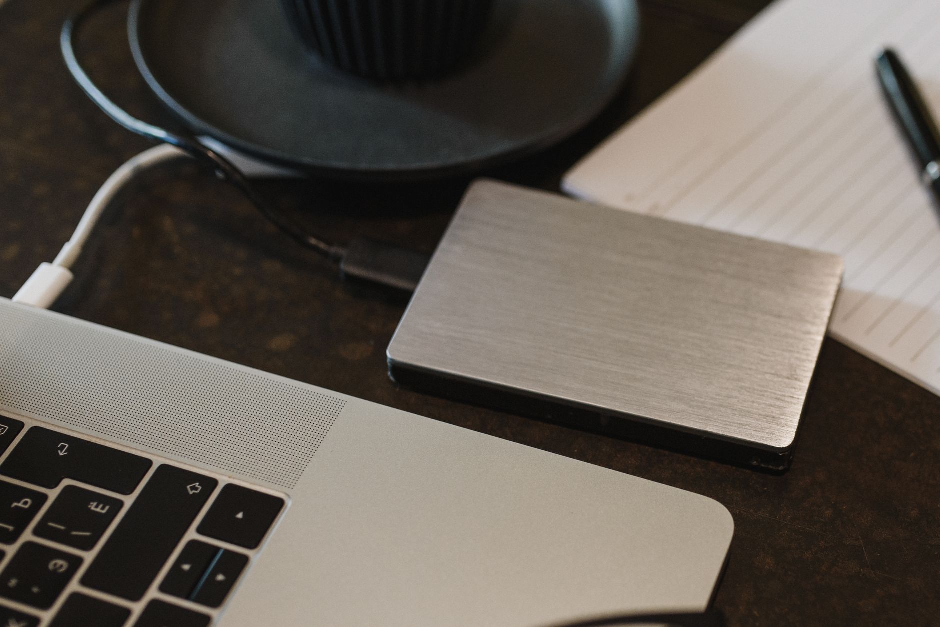 an external hard drive sitting beside a laptop